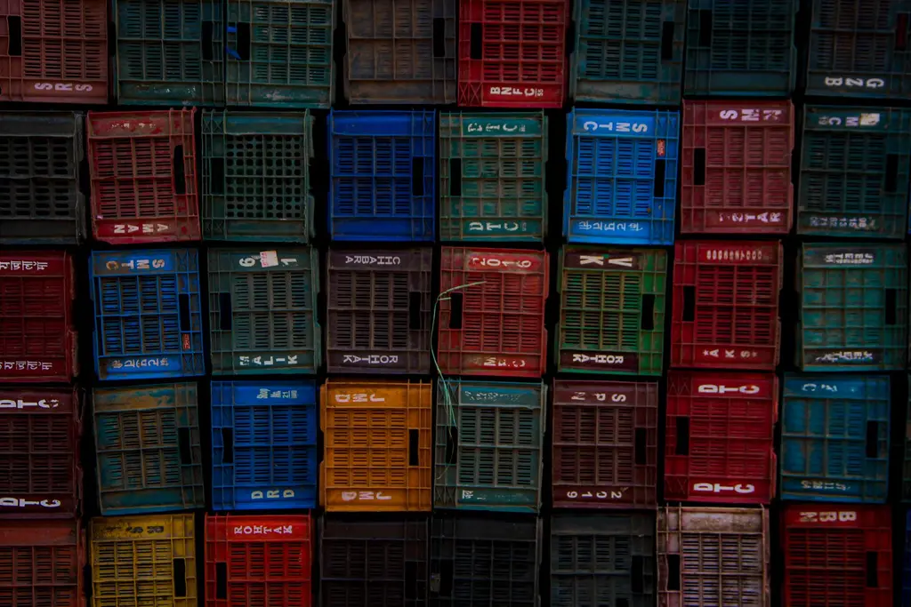 Stacked plastic crates in a working warehouse